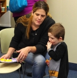 Pat's daughter, Sarah, and her grandson, Mason, enjoy the food.