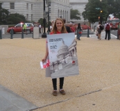 Woman with sign saying "Don't Ignore Kids Health"