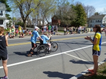 man pushing another man who is pedaling