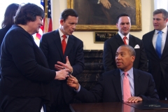 Governor Patrick gives Rose a pen while Treasurer Grossman talks.