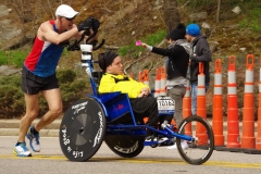 man pushing wheelchair