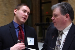 Christopher Yancich, aid to State Rep. Jeffrey Roy, speaks to Steve Higgins, Executive Director of IACIL