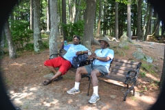 two men relax on a bench