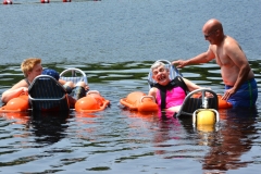 two people enjoy the floating beach chairs