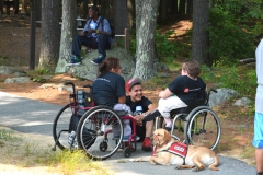 three people talk in the shade