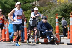 man pushing wheelchair
