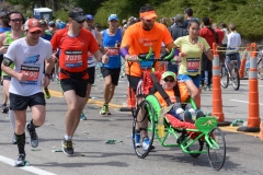 man pushing wheelchair