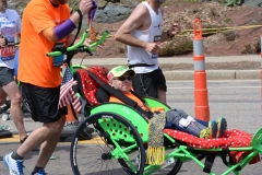 man pushing wheelchair - passenger smiling