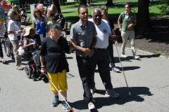 Two marchers with white canes