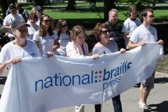 People carrying National Braille Press banner