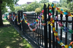 paper chain of disability messages on fence
