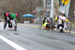 Two handcyclists and a wheelchair racer