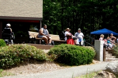 People relaxing on a bench in the sun