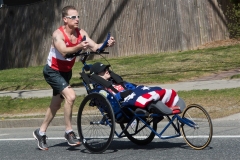 man pushing wheelchair