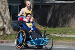 man pushing wheelchair