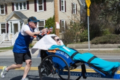 man pushing woman in wheelchair