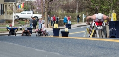 Several wheelchair racers coming up the hill