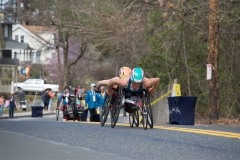 Two women wheelchair racers coming up the hill