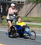 man pushing young man in wheelchair