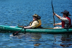 A boy and a man in a kayak