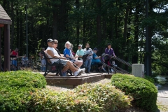 people relaxing, listening to the band