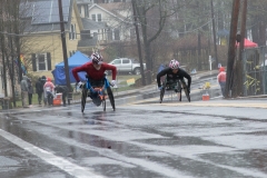 2 wheelchair racers coming up the hill