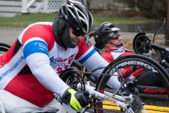 photo is close up of 2 handcycle racers