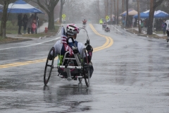 Photo from behind of handcycle racer from Framingham — with Dennis Moran.