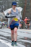Photo of a smiling early starting woman wearing a garbage bag.