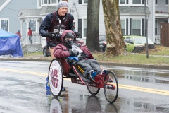 A racer pushing a wheelchair.