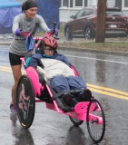 woman pushing a woman in a wheelchair.