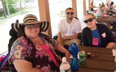 Three people enjoy the pavilion shade