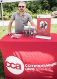 Man at Commonwealth Care Alliance table (red sunglasses!)