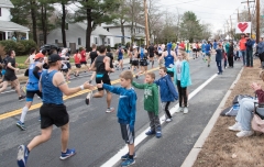 Kids high fiving runners