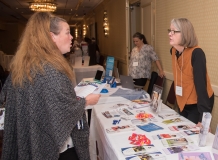 Woman talks to Leslie Leslie at the Federation for Children with Special Needs table