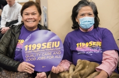 2 Women with 1199SEIU sign indoors