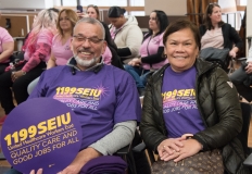 couple with 1199SEIU signs indoors