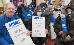 people in blue from Mass Senior Action Council indoors