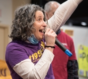 Becca Gutman rallies the crowd  indoors.