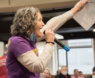 Becca Gutman rallies the crowd  indoors.