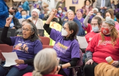 Women cheering with fists in the air. , indoors.