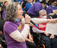 Becca Gutman rallies the crowd indoors