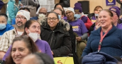 women smiling in the crowd indoors