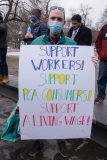 Man with sign:  SUpport workers!  Support PCA Consumers!  Support a Living Wage!