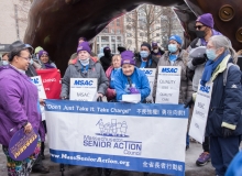 MA Senior Action Council members behind large sign