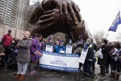 MA Senior Action Council members behind large sign under Embrace