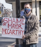 Advocate with sign: "Shame on Mayor McCarthy"