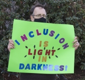 Protestor: Inclusion is Light in Darkness