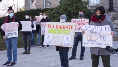 Protestors: "Human Rights Not Holiday Lights", Illuminate History", "Disabled People Died Here. Have some respect, please."