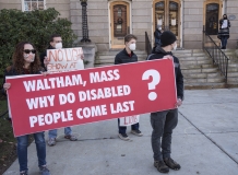 Protestors with Banner: Waltham Mass Why do Disabled People Come Last?